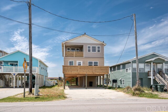 beach home featuring a carport and concrete driveway