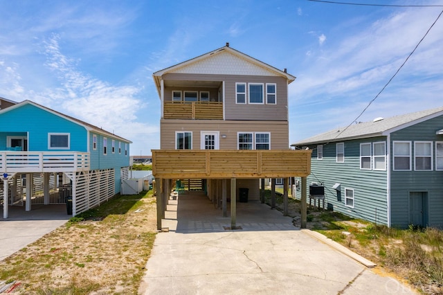 coastal home featuring a carport and concrete driveway