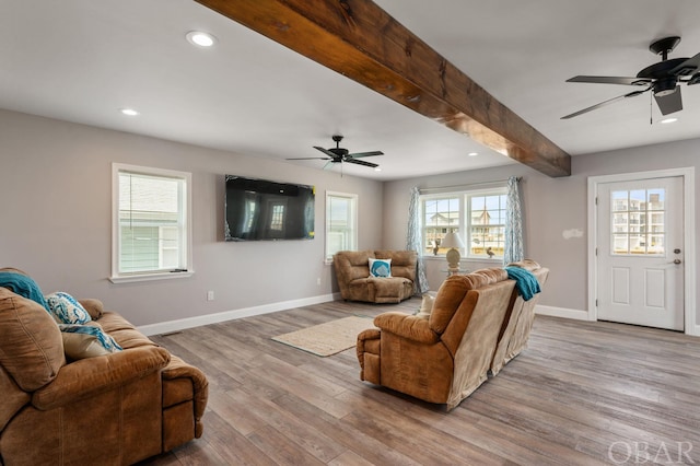 living area featuring recessed lighting, wood finished floors, beam ceiling, and baseboards