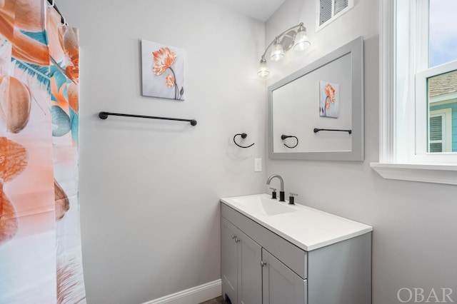 full bath with baseboards, visible vents, and vanity