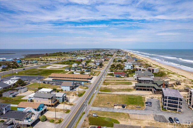 drone / aerial view with a water view, a residential view, and a view of the beach