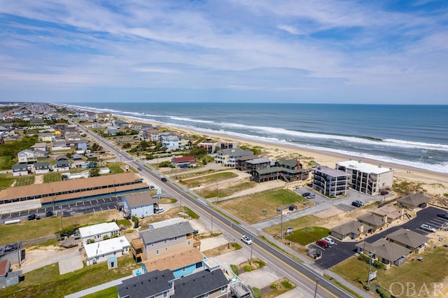 bird's eye view with a water view and a beach view