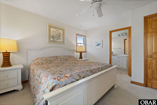 bedroom with ensuite bathroom, ceiling fan, baseboards, and light colored carpet