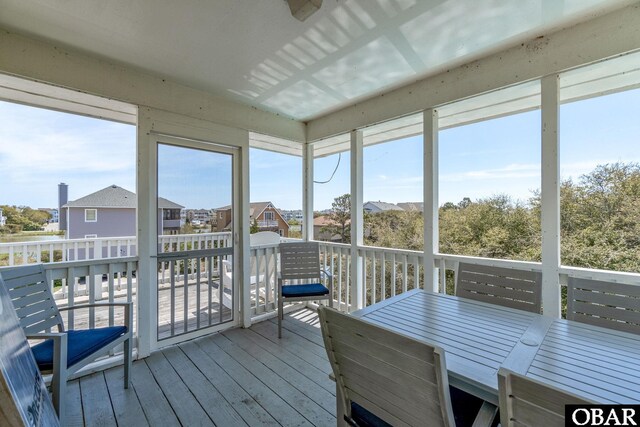 unfurnished sunroom with a residential view