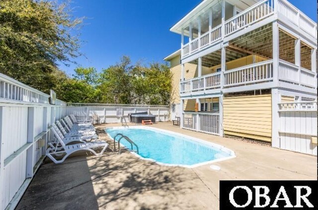 view of pool with a patio area, fence private yard, a fenced in pool, and a jacuzzi