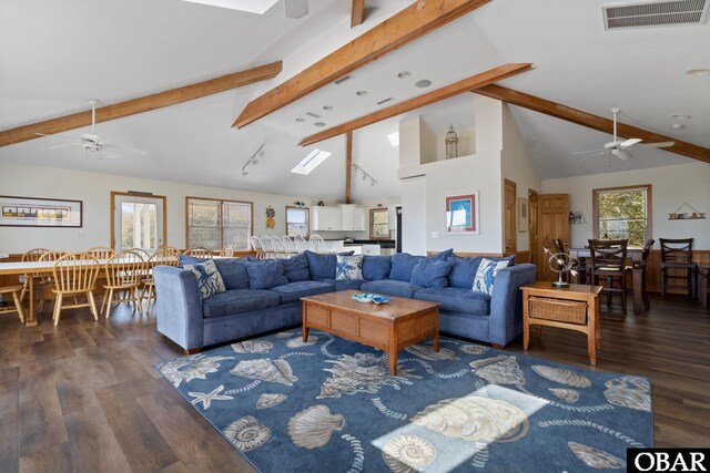 living room featuring ceiling fan, visible vents, dark wood-type flooring, and beamed ceiling