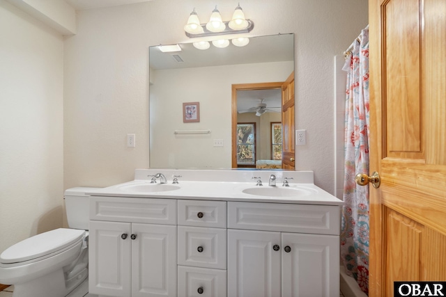 ensuite bathroom featuring a sink, ensuite bath, and double vanity