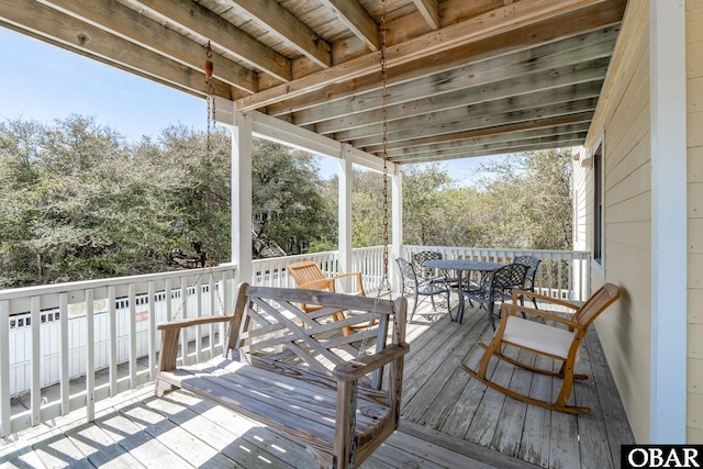 wooden terrace with outdoor dining area