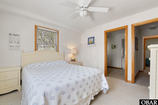 bedroom with light carpet, ceiling fan, and baseboards