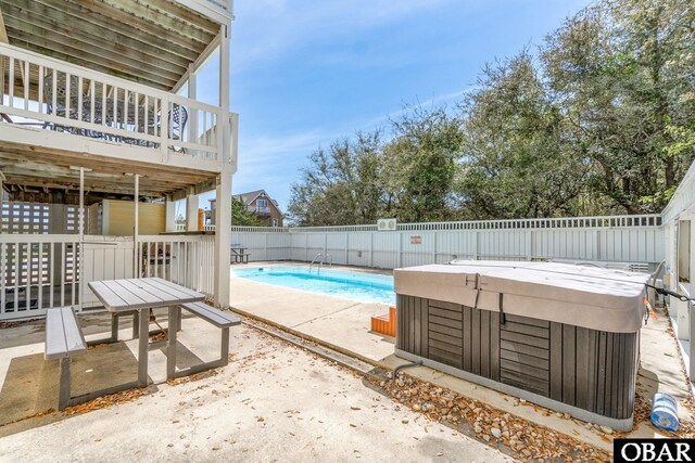 view of pool featuring a hot tub, a fenced in pool, a fenced backyard, a deck, and a patio area