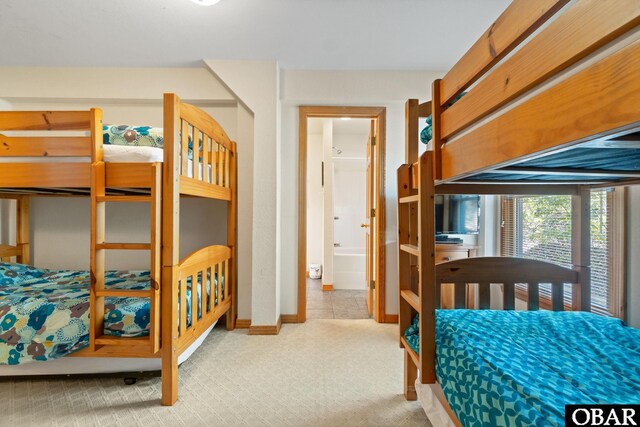 bedroom with light colored carpet and baseboards