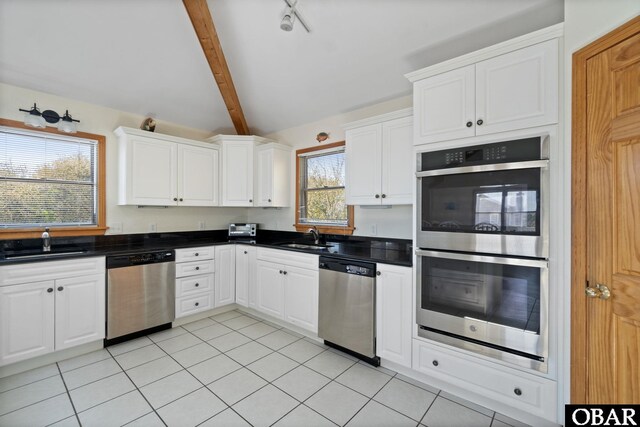 754 Cormorant Trl Lot 79, Corolla, NC 27927 - kitchen featuring stainless steel appliances, dark countertops, white cabinetry, and light tile patterned floors