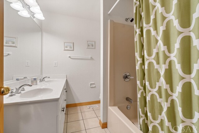 bathroom with shower / tub combo, baseboards, a sink, and tile patterned floors