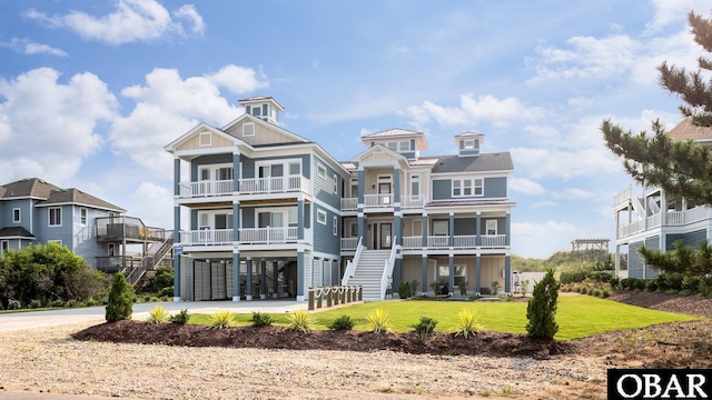 909 Lighthouse Dr Lot # 8, Corolla, NC 27927 - rear view of property with a balcony, stairs, a carport, and a yard