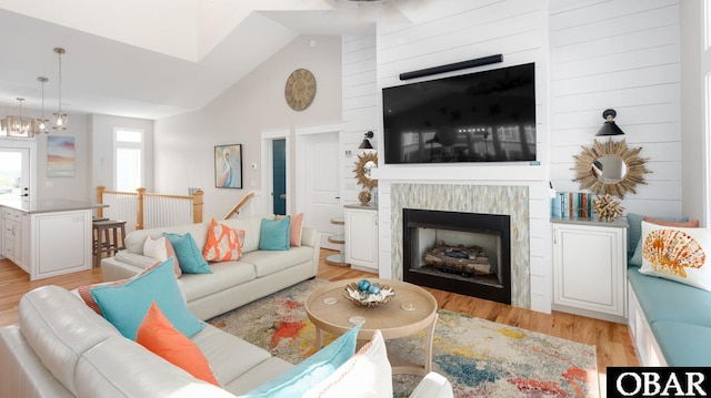 909 Lighthouse Dr Lot # 8, Corolla, NC 27927 - living area with a fireplace, light wood-style floors, high vaulted ceiling, and a chandelier
