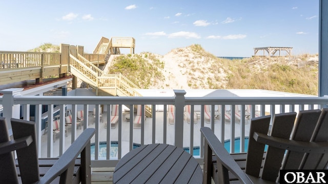 909 Lighthouse Dr Lot # 8, Corolla, NC 27927 - wooden deck featuring a community pool and stairway