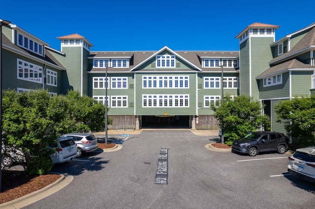 view of building exterior featuring uncovered parking