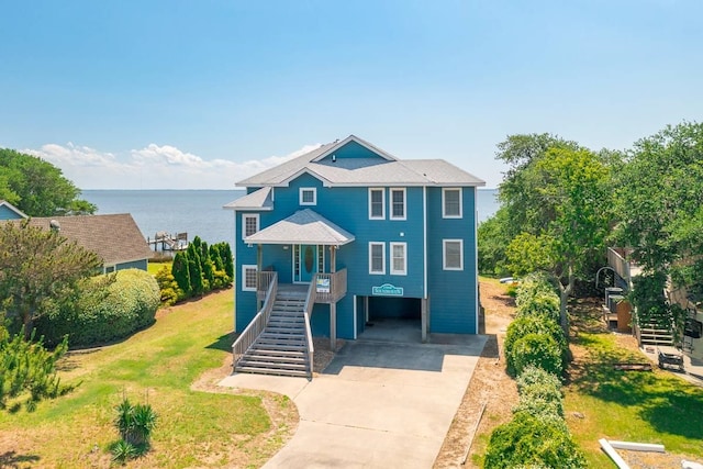 1386B Duck Rd Lot 34, Duck, NC 27949 - coastal inspired home featuring a water view, a carport, a porch, concrete driveway, and stairs