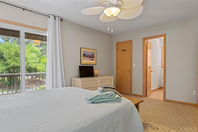 bedroom featuring a textured ceiling, a ceiling fan, baseboards, access to exterior, and ensuite bath