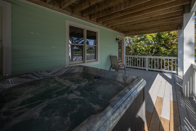 wooden deck with a hot tub