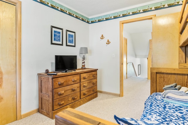 bedroom featuring light colored carpet and baseboards