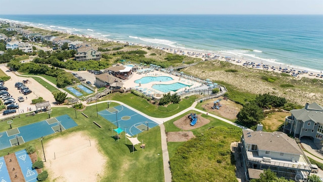 birds eye view of property featuring a beach view and a water view