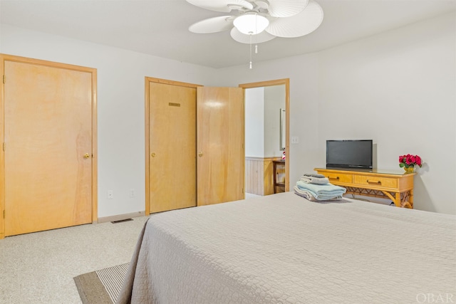 bedroom with carpet, visible vents, baseboards, and ceiling fan