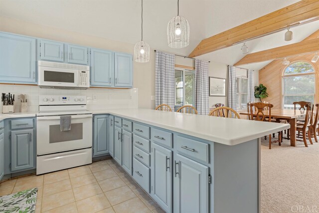 kitchen featuring white appliances, light countertops, and a peninsula