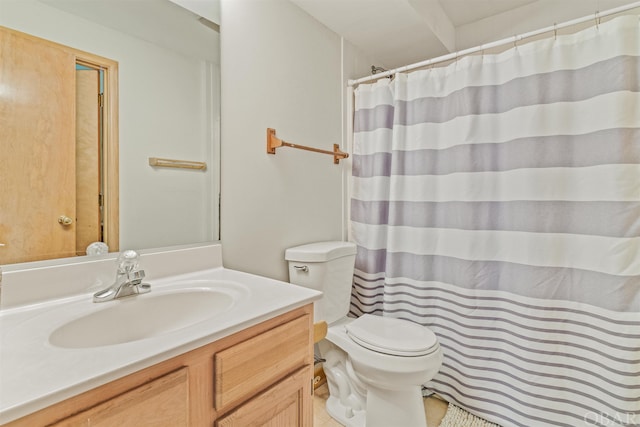 bathroom featuring toilet and vanity