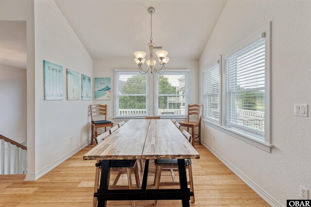 759 Ridge Point Dr Lot 42, Corolla, NC 27927 - dining area featuring vaulted ceiling, light wood-style floors, a chandelier, and baseboards
