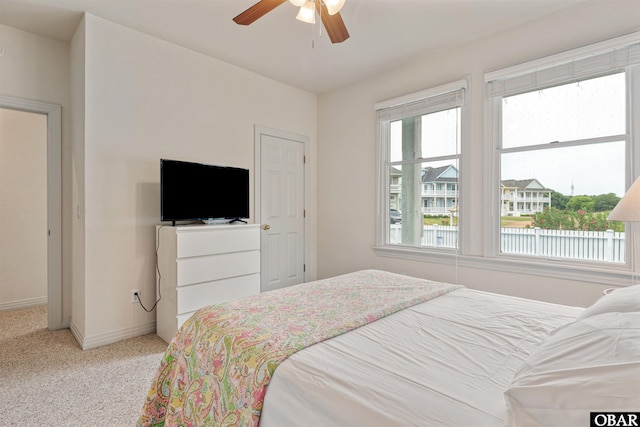 759 Ridge Point Dr Lot 42, Corolla, NC 27927 - bedroom featuring multiple windows, baseboards, light carpet, and a ceiling fan