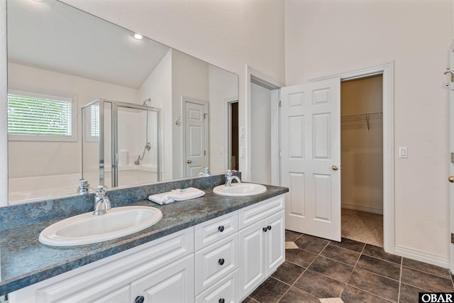 759 Ridge Point Dr Lot 42, Corolla, NC 27927 - bathroom featuring a shower stall, double vanity, a spacious closet, vaulted ceiling, and tile patterned floors