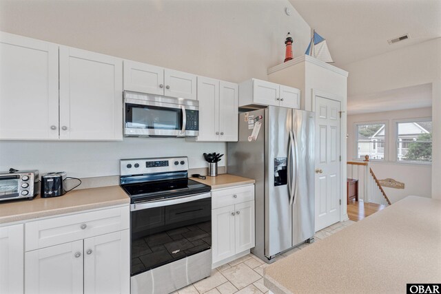 759 Ridge Point Dr Lot 42, Corolla, NC 27927 - kitchen featuring appliances with stainless steel finishes, white cabinets, and light countertops