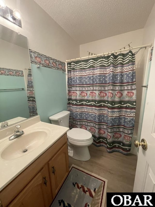 25273 Sea Isle Hills Dr Lot 5-2, Waves, NC 27982 - bathroom with vanity, a textured ceiling, toilet, wood finished floors, and curtained shower