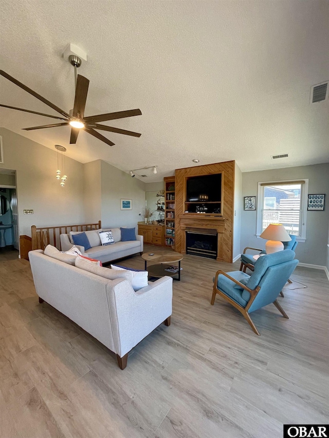 25273 Sea Isle Hills Dr Lot 5-2, Waves, NC 27982 - living area featuring a textured ceiling, a ceiling fan, wood finished floors, vaulted ceiling, and baseboards