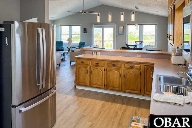 25273 Sea Isle Hills Dr Lot 5-2, Waves, NC 27982 - kitchen with freestanding refrigerator, vaulted ceiling, light wood-type flooring, a textured ceiling, and brown cabinetry
