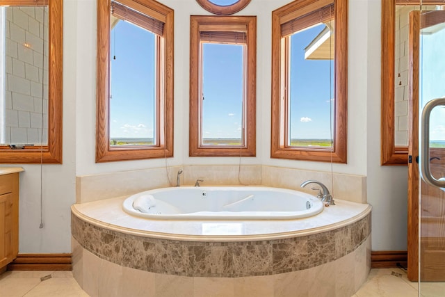 full bath with a bath, tile patterned flooring, and vanity