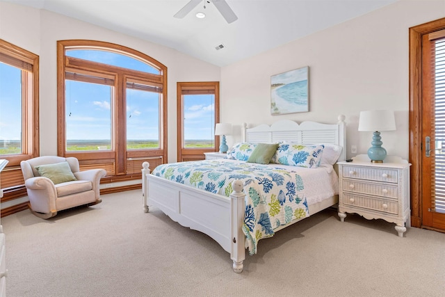 carpeted bedroom with ceiling fan, visible vents, and vaulted ceiling