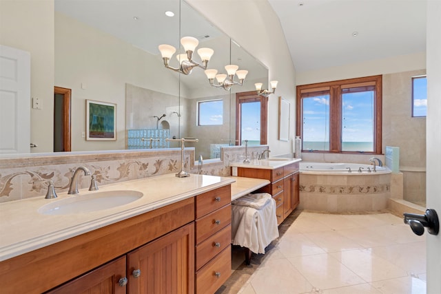 bathroom with lofted ceiling, tile patterned flooring, vanity, and a chandelier