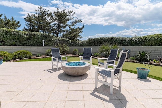 view of patio / terrace with fence private yard and a fire pit