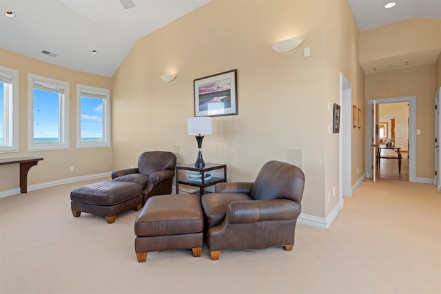 sitting room featuring visible vents, baseboards, vaulted ceiling, and light colored carpet