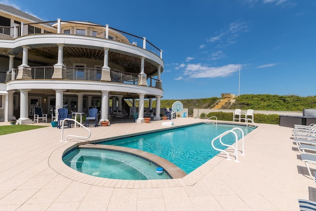 view of pool featuring a patio area and a pool with connected hot tub