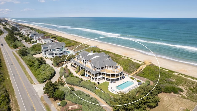 birds eye view of property featuring a water view and a view of the beach