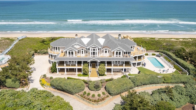 birds eye view of property with a water view and a view of the beach