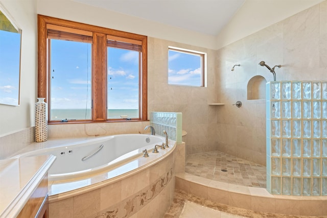 full bathroom featuring a garden tub, vaulted ceiling, and walk in shower