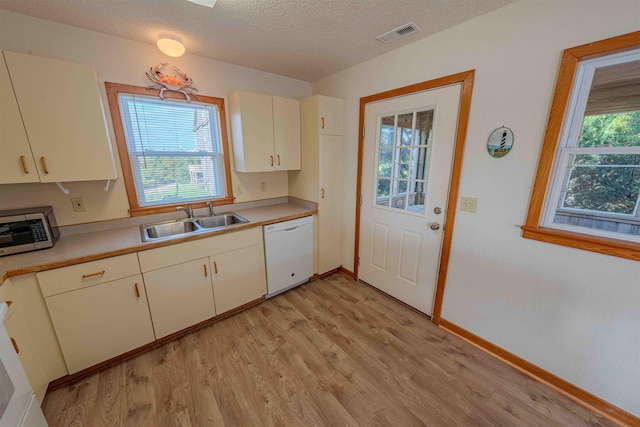 40270 Croaker Ct Lot D, Avon, NC 27915 - kitchen featuring white dishwasher, a sink, stainless steel microwave, light wood finished floors, and light countertops