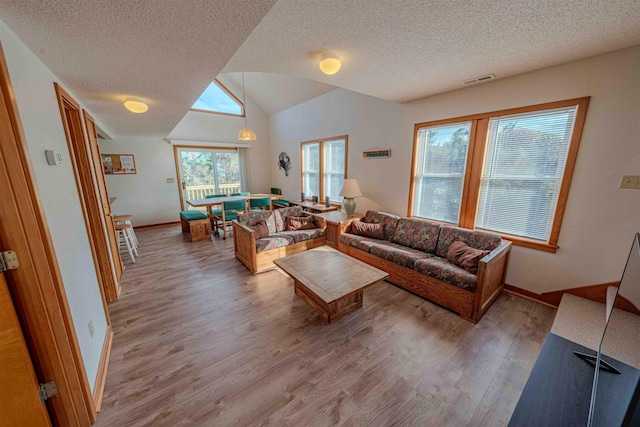 40270 Croaker Ct Lot D, Avon, NC 27915 - living area with a textured ceiling, wood finished floors, lofted ceiling, and baseboards