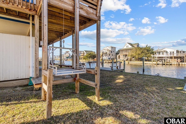 50096 Freebooter Ct Lot 178, Frisco, NC 27936 - view of dock featuring a water view, boat lift, a residential view, and a yard