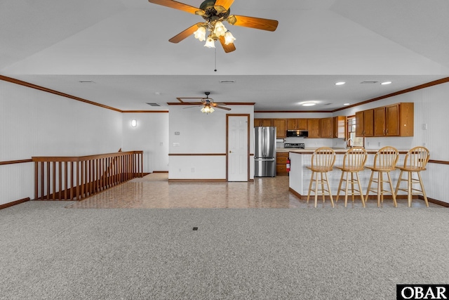 50096 Freebooter Ct Lot 178, Frisco, NC 27936 - kitchen featuring a breakfast bar, light countertops, ornamental molding, appliances with stainless steel finishes, and brown cabinets