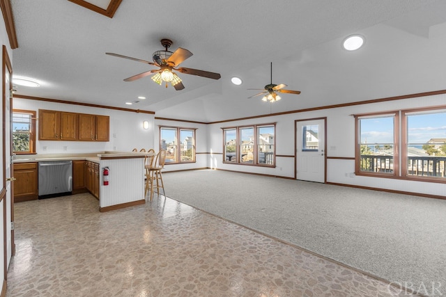 50096 Freebooter Ct Lot 178, Frisco, NC 27936 - kitchen featuring brown cabinetry, a breakfast bar, open floor plan, light countertops, and stainless steel dishwasher